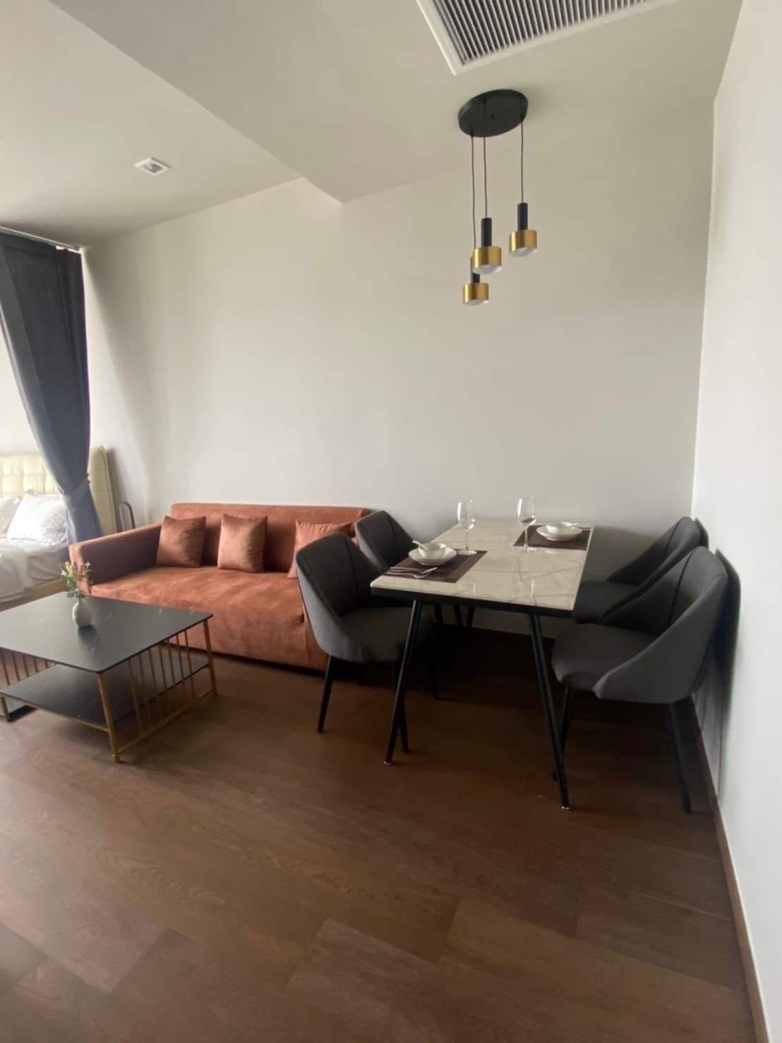 Warm wood-toned 1BR with city-view balcony — IDEO Q Victory