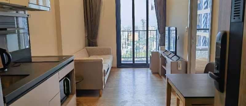Open-view balcony over low-rise Bangkok — Oka Haus